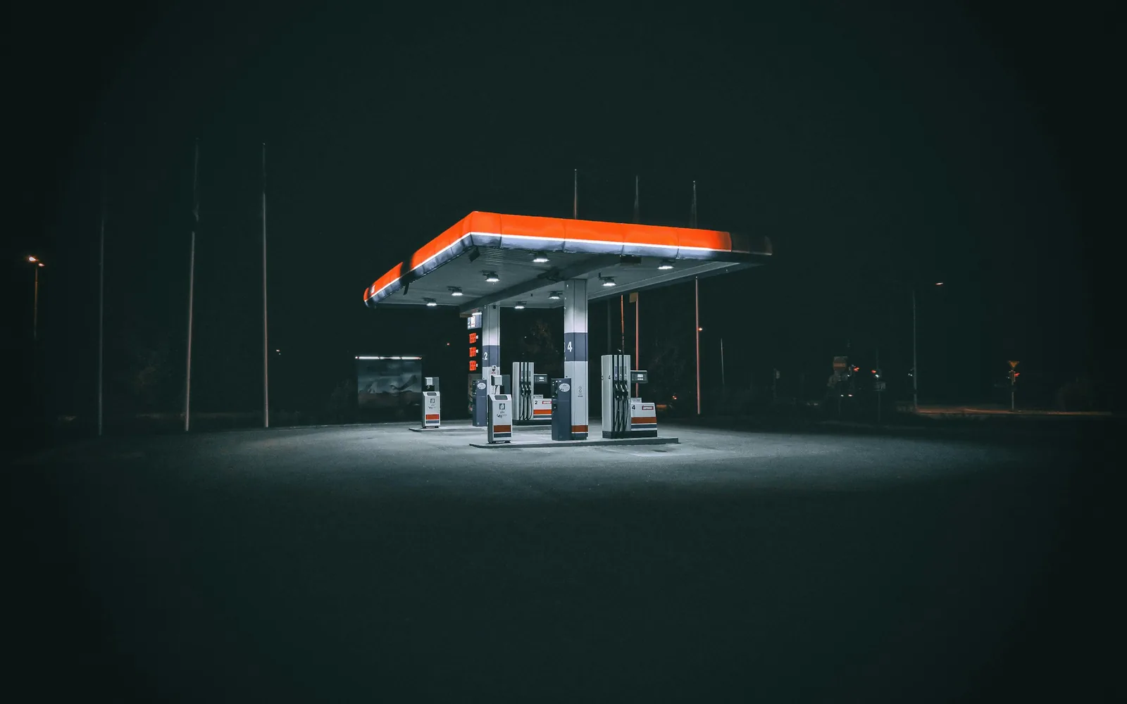 Fuel station forecourt at night