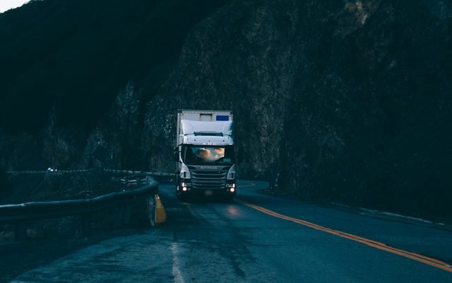 Truck driving out of a mountain tunnel