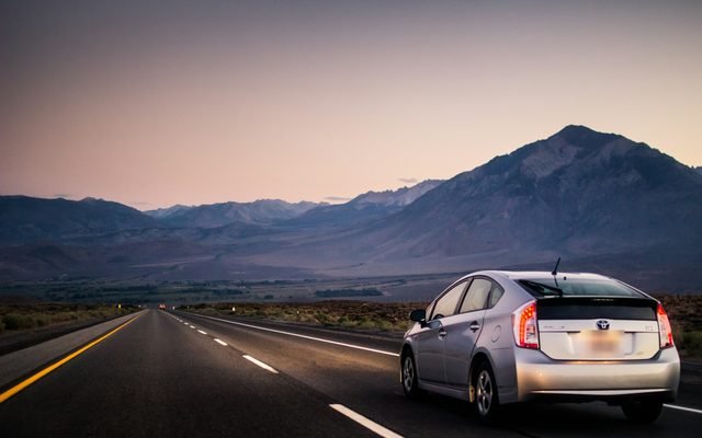 Car on an open highway at dusk